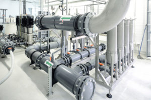 new shiny pipes and large pumps in industrial boiler room